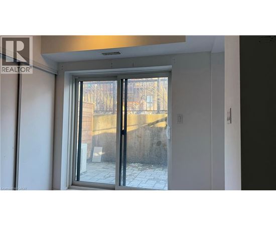A realtor photo of a room with a glass door leading to a balcony.