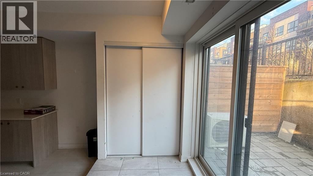 A room with a sliding door and a window overlooking a construction site.