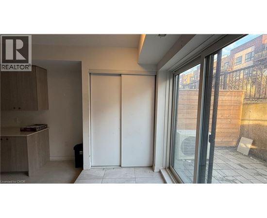 A room with a sliding door and a window overlooking a construction site.