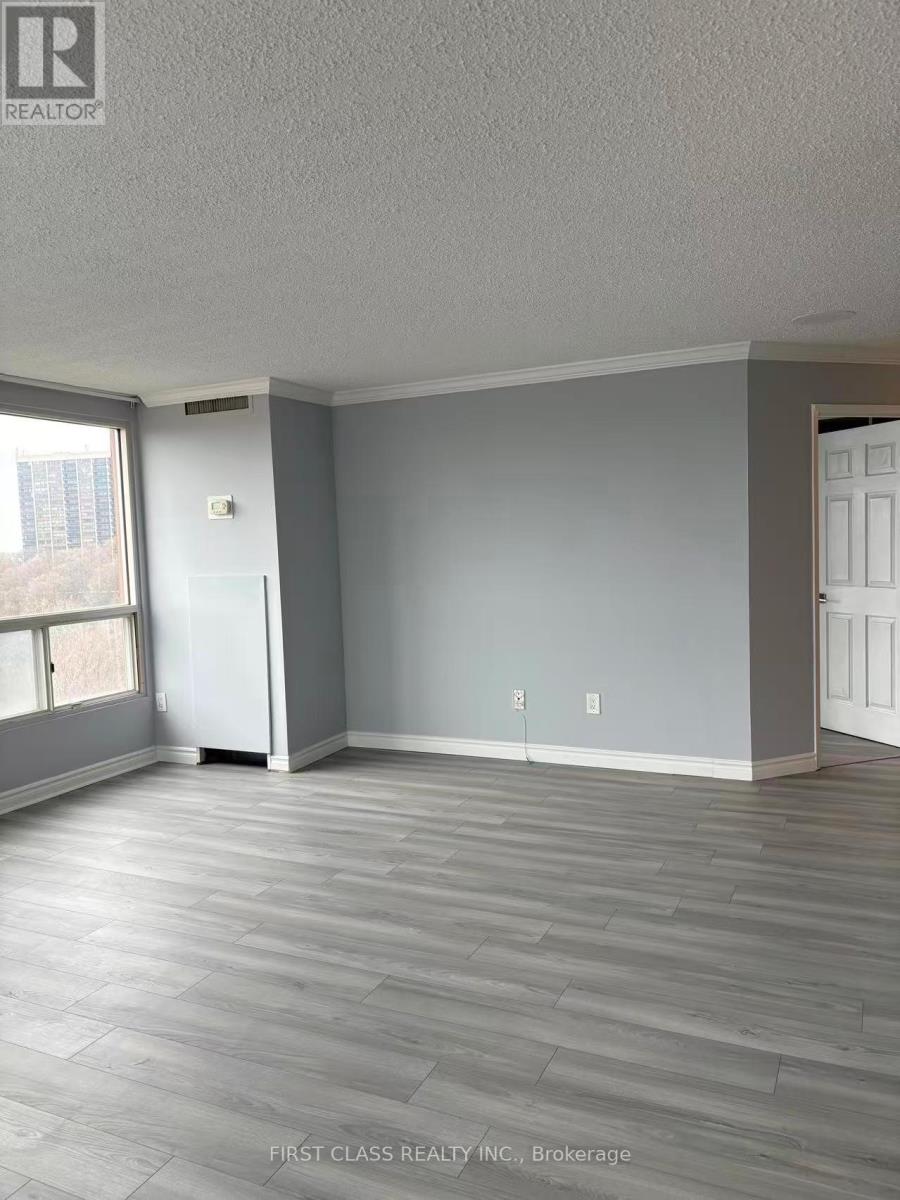 A room with a grey floor and a white door.