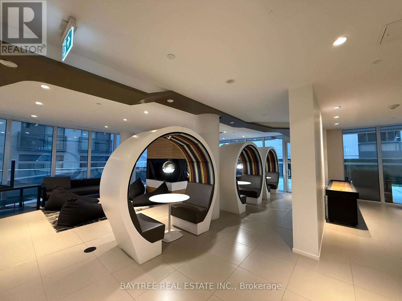 A modern office space with a curved white structure in the middle.