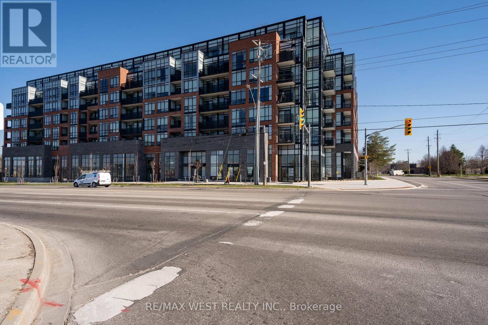 A modern multi-story building with a glass facade is the main focus of the image.