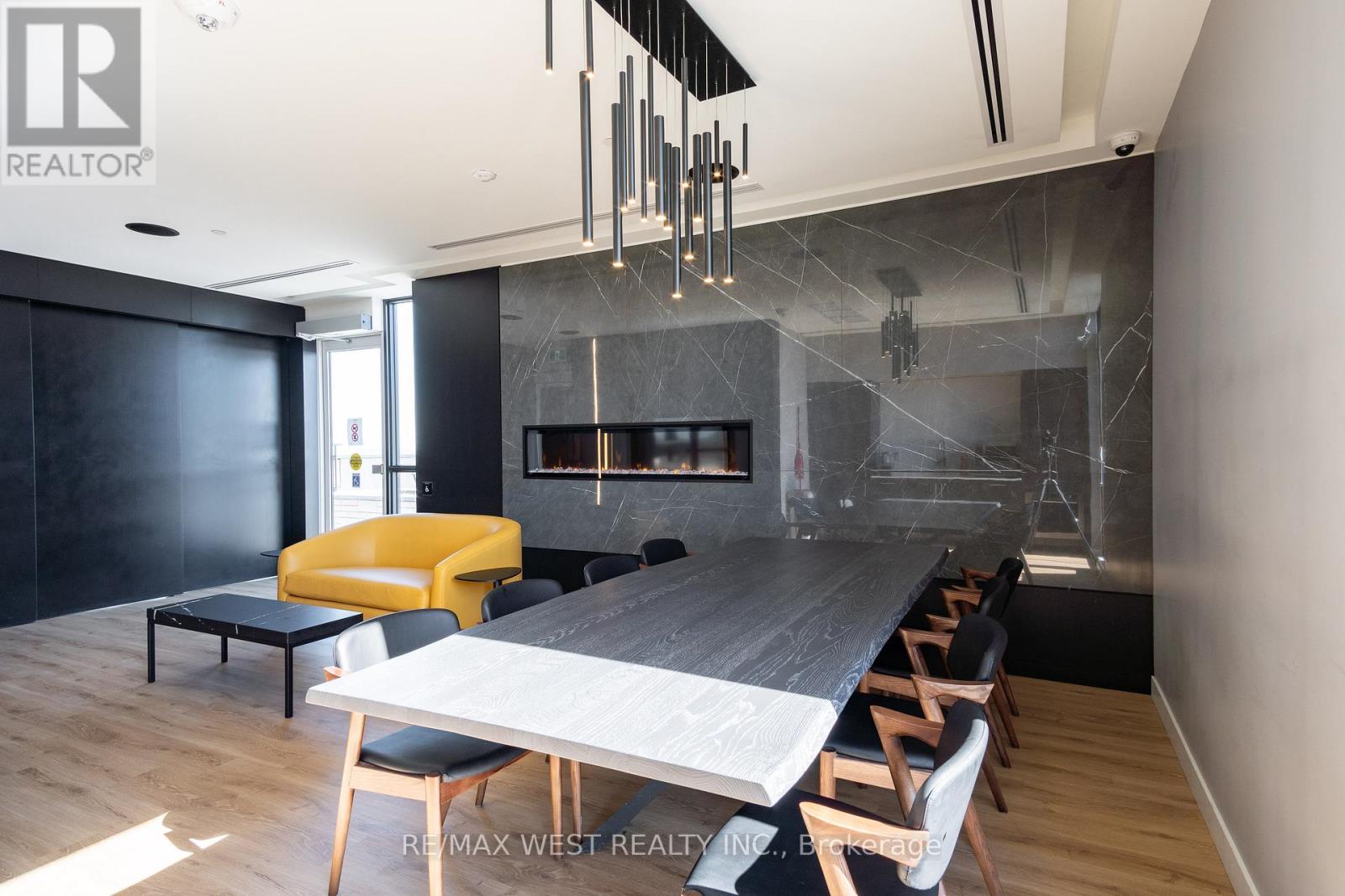 A modern dining room with a long table and chairs.