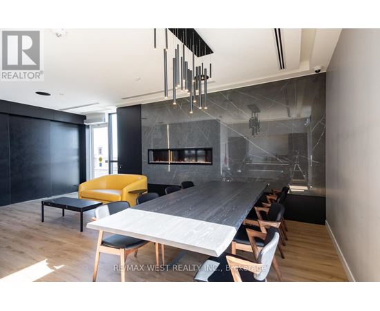 A modern dining room with a long table and chairs.