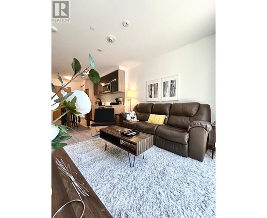 A living room with a brown leather couch and a coffee table.