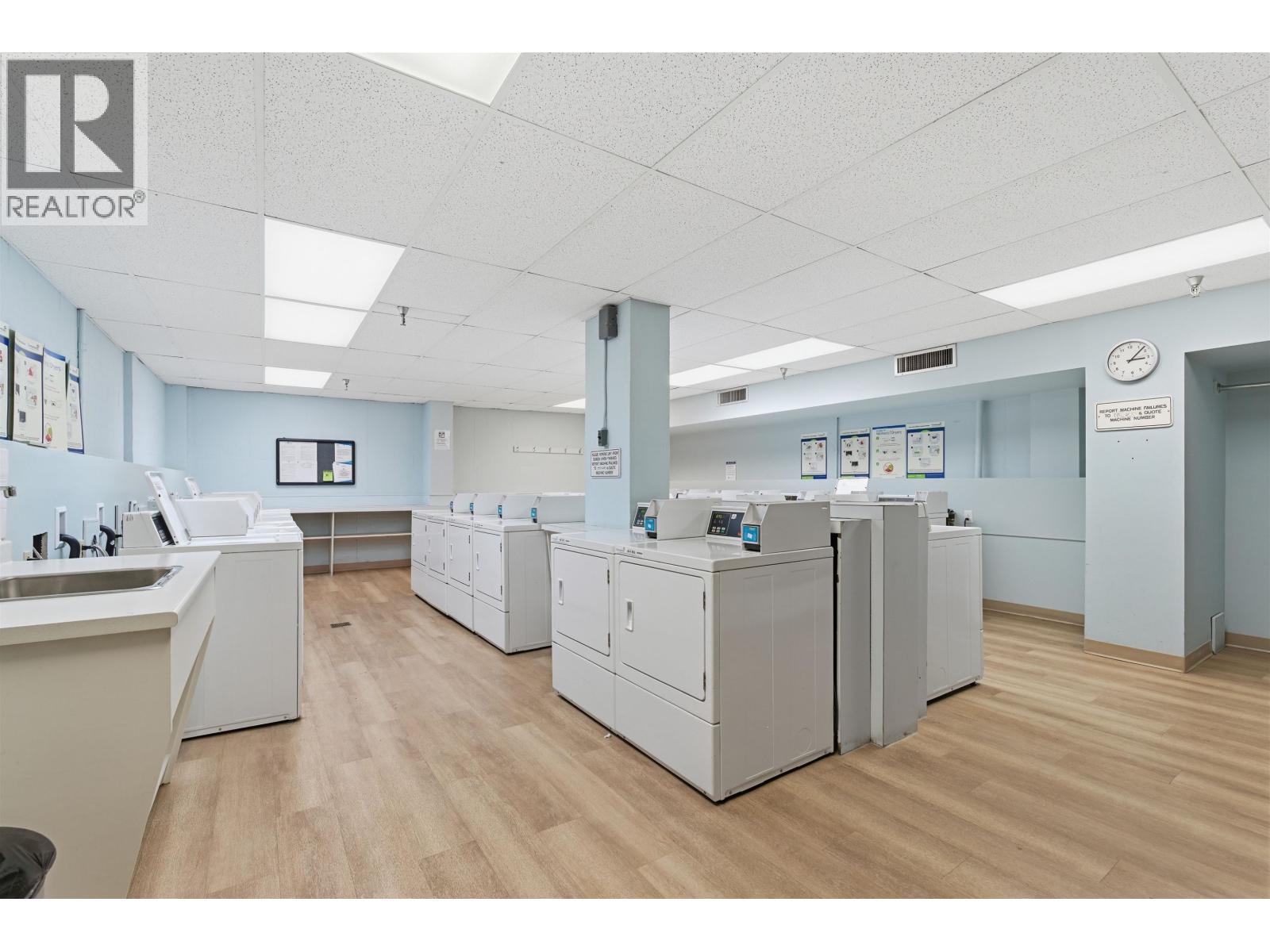 A clean, well-lit office space with a realtor logo on the wall.