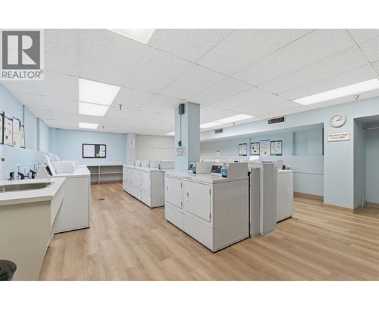 A clean, well-lit office space with a realtor logo on the wall.