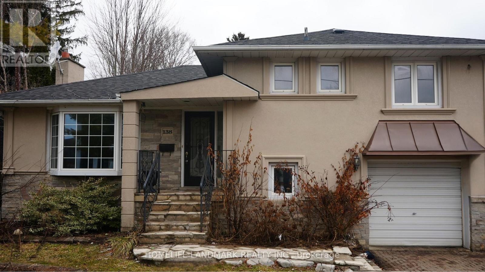A house with a brown roof and a white garage door.