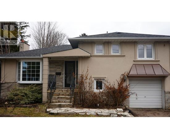 A house with a brown roof and a white garage door.