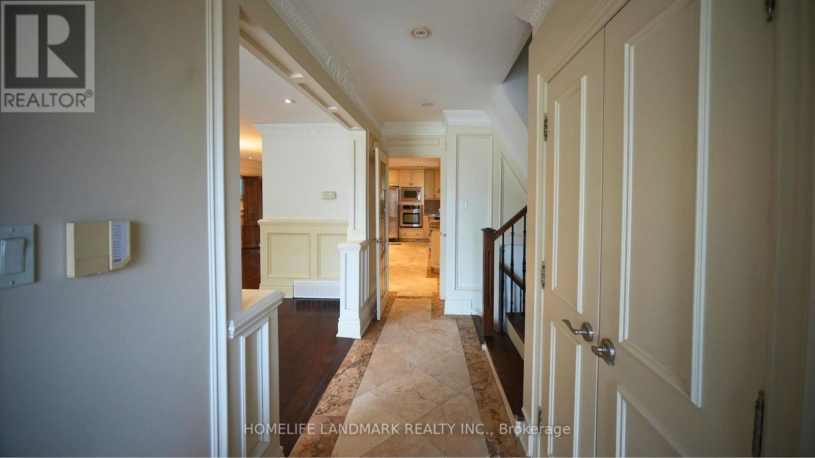 A hallway with a carpeted floor and white walls.