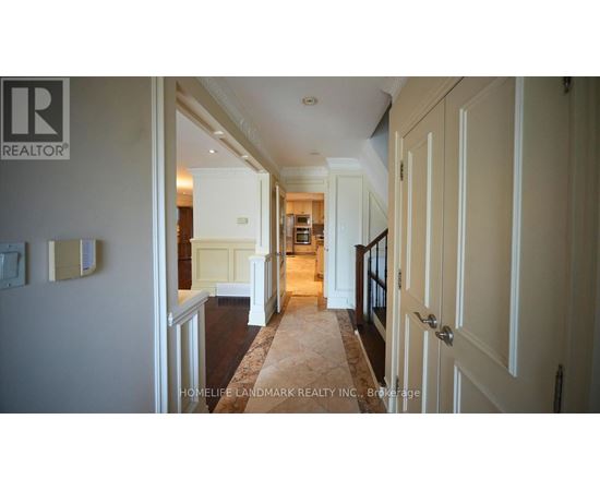 A hallway with a carpeted floor and white walls.