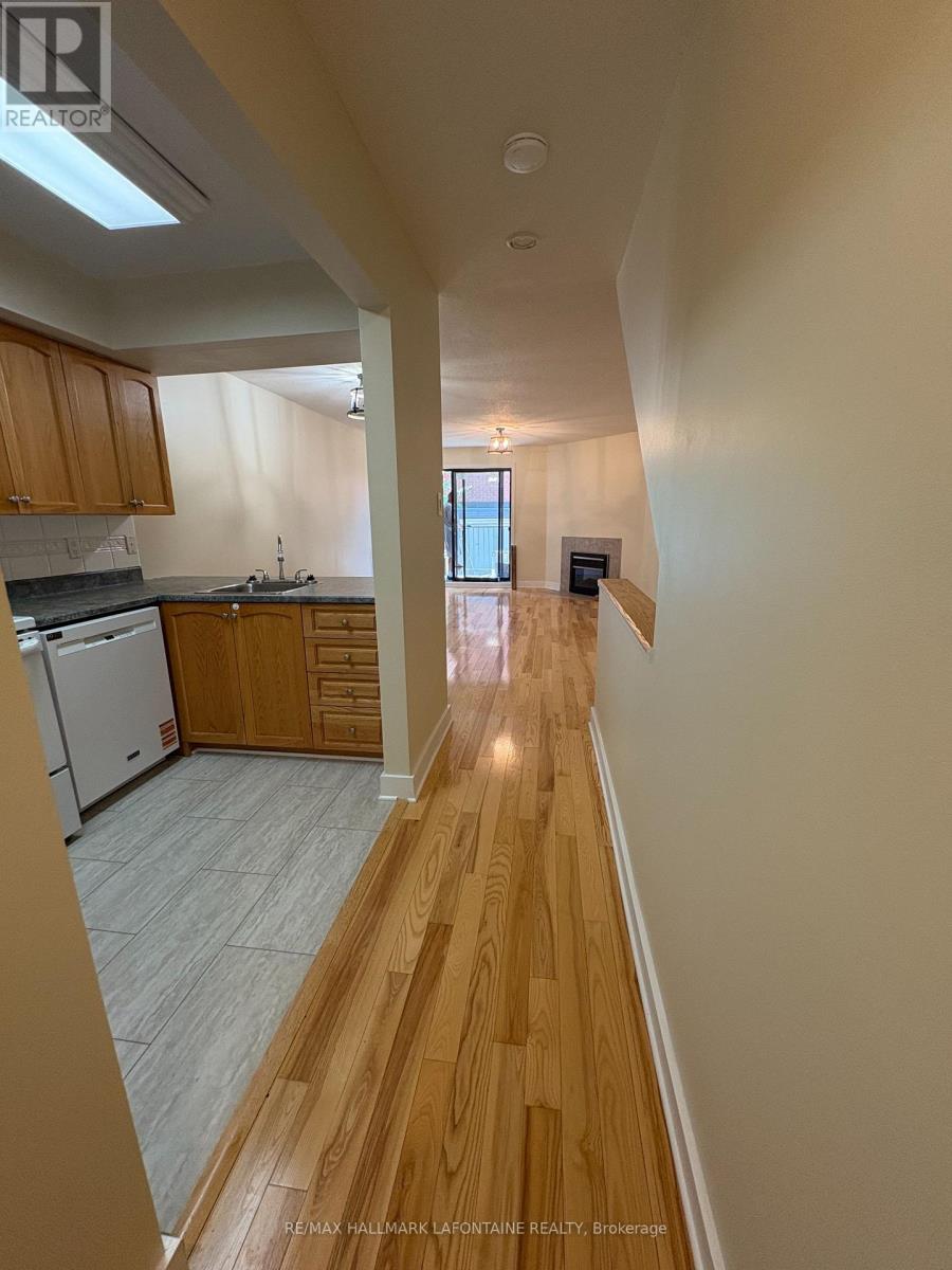 A long hallway with wooden floors and white walls.