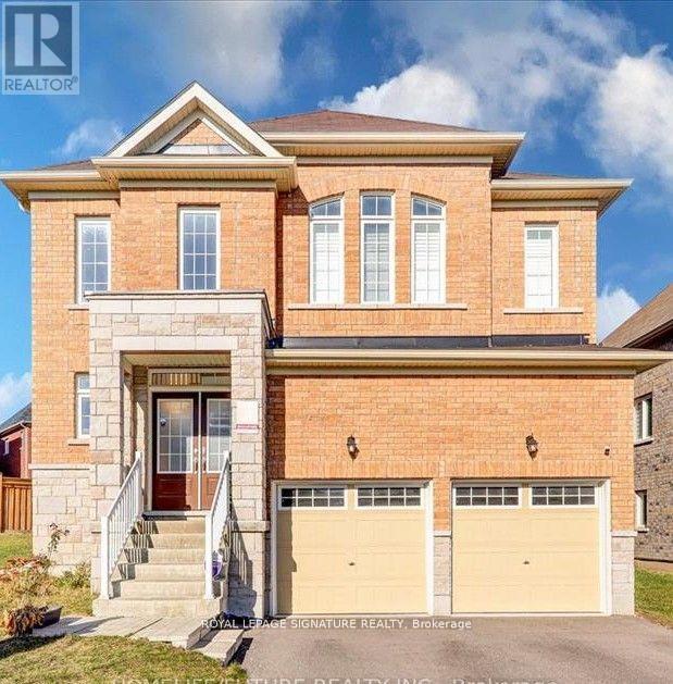 A two-story brick house with a garage and a front porch.