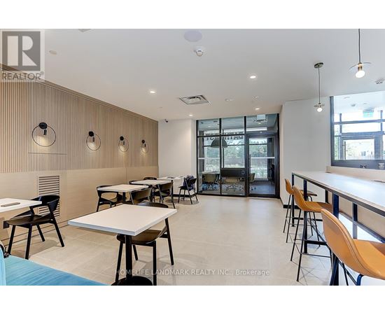 A modern dining area with wooden walls and tables with chairs.
