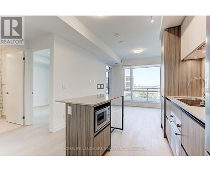 A modern kitchen with wooden cabinets and a large island.