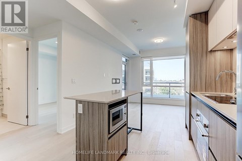 A modern kitchen with wooden cabinets and a large island.