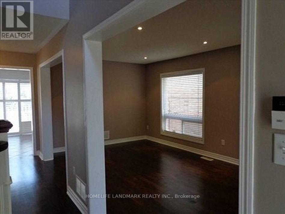 A room with brown walls and a window with blinds.