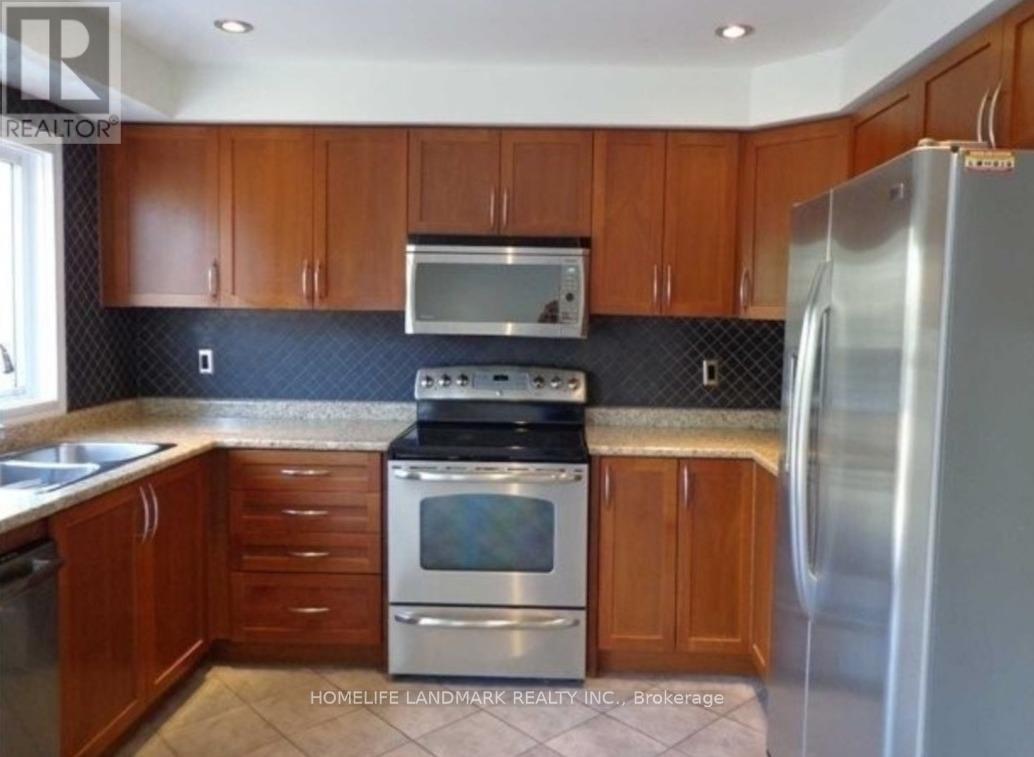 A kitchen with wooden cabinets and a stainless steel refrigerator.