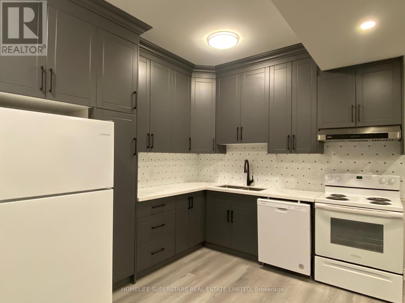 A kitchen with a white fridge and a white dishwasher.