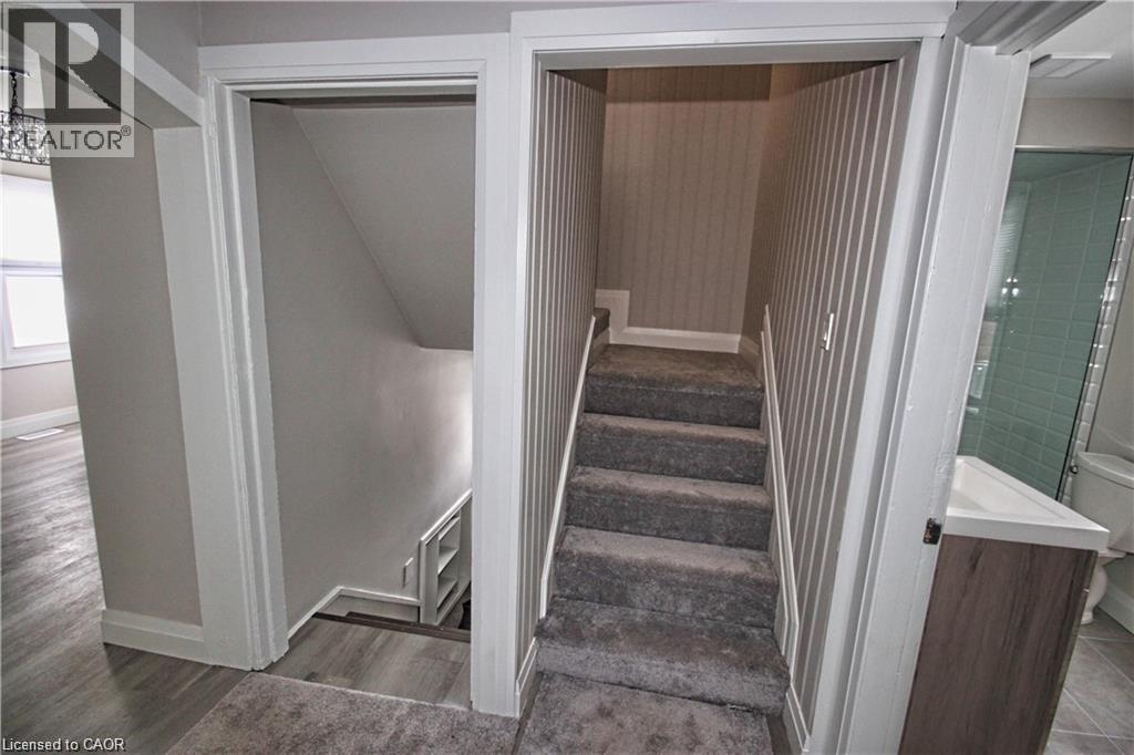 A stairway with a carpeted floor leads to a second floor.
