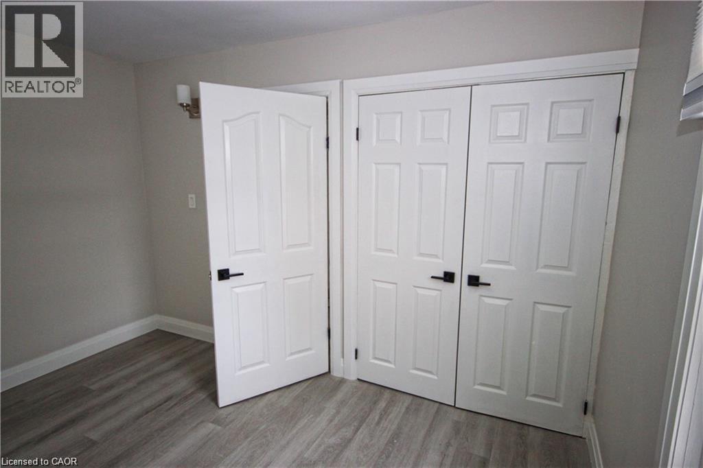 A room with two white doors and a wooden floor.
