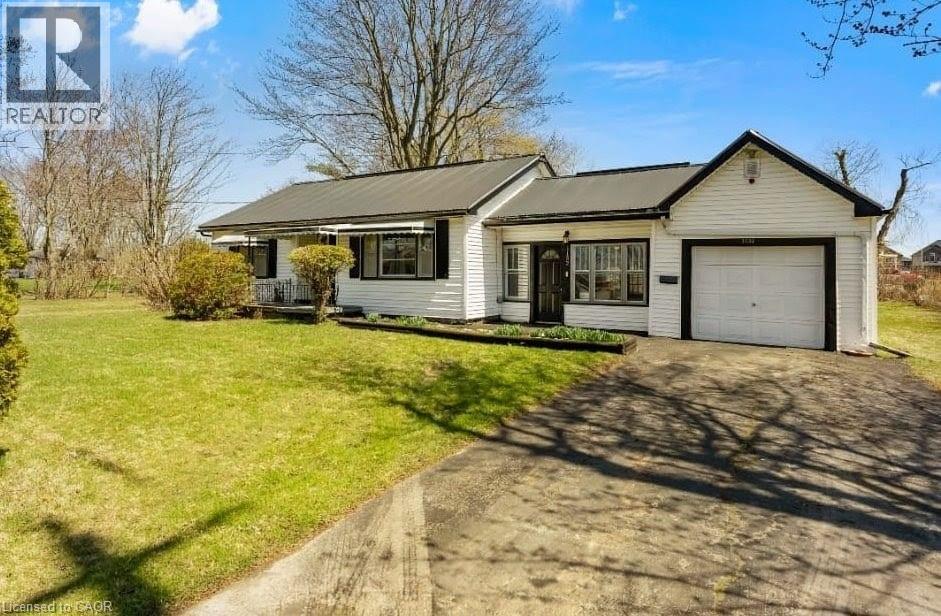 A house with a white garage door is for sale.