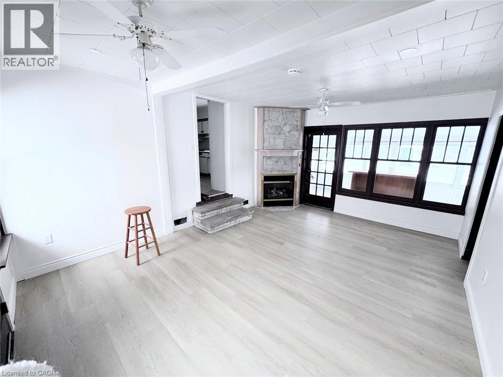 A room with a wooden floor and a ceiling fan.