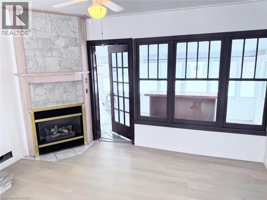 A room with a fireplace and a ceiling fan.