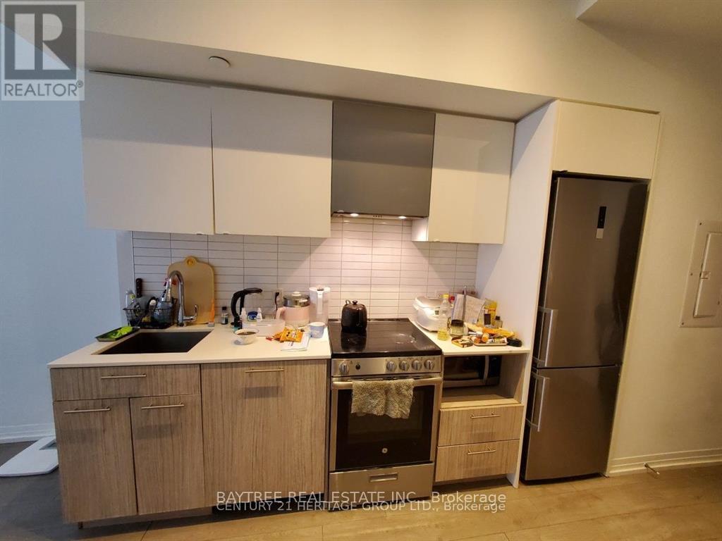 A kitchen with wooden cabinets and stainless steel appliances.