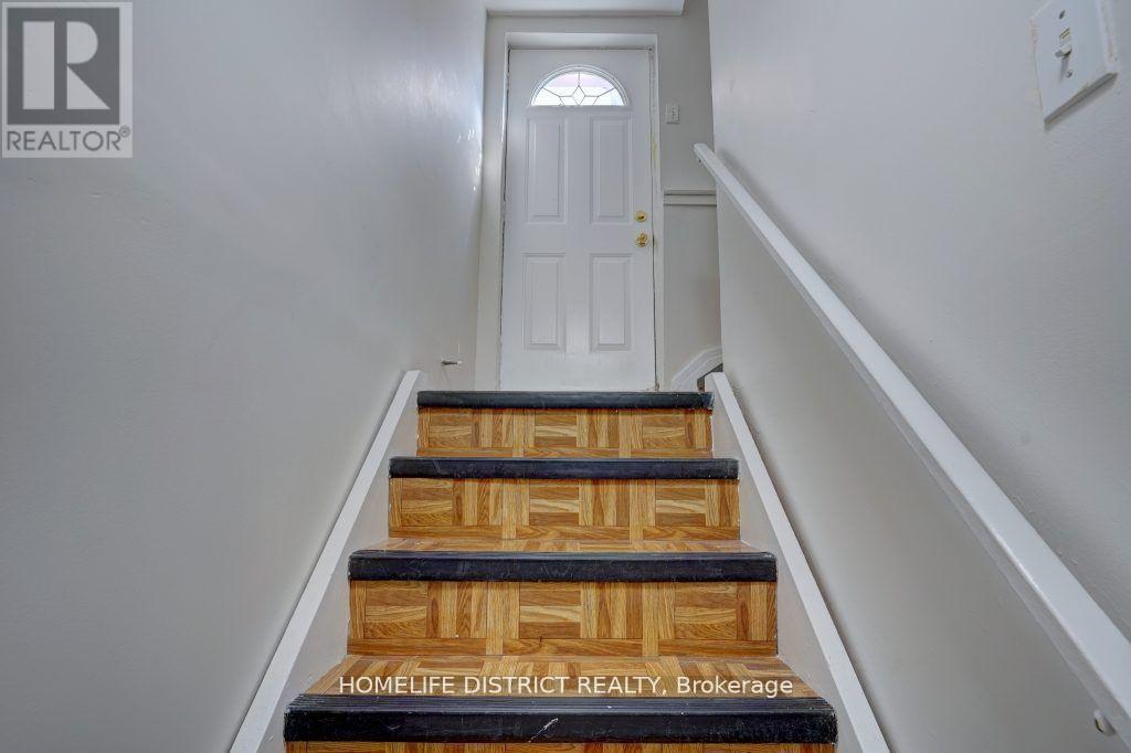 A set of stairs leading to a white door.