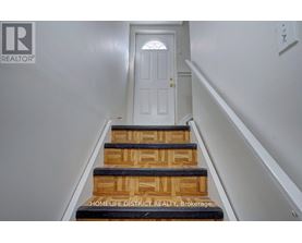 A set of stairs leading to a white door.