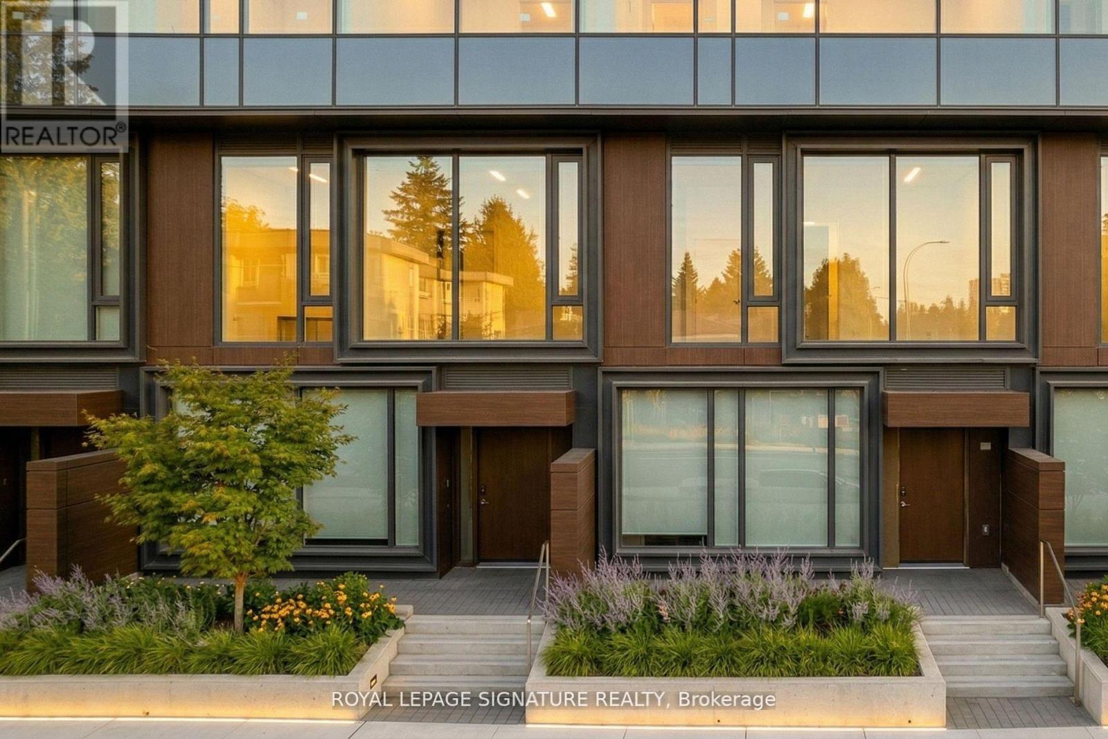A modern building with the words "Royal LePage Signature Realty, Brokerage" on the front.