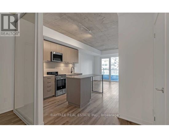 A modern kitchen with a microwave above the oven and a countertop with a sink.