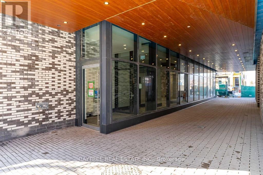 A building with a brick wall and glass doors.