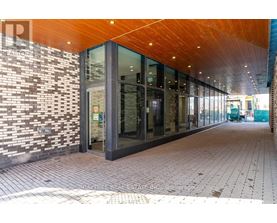 A building with a brick wall and glass doors.