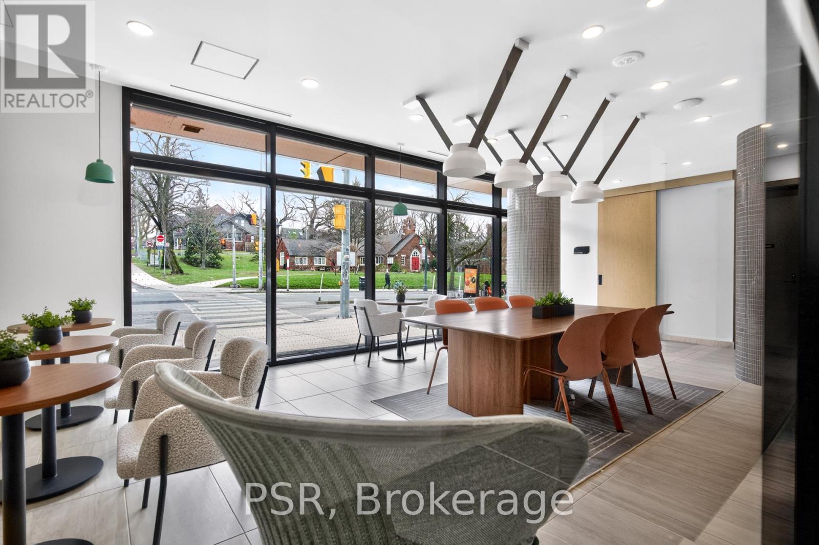 A modern office space with a view of the outside through large windows.
