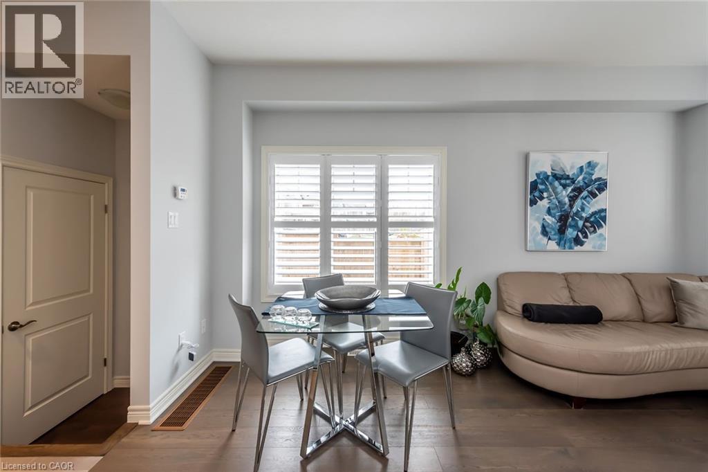 A dining room with a table and chairs.