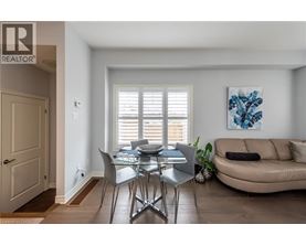 A dining room with a table and chairs.