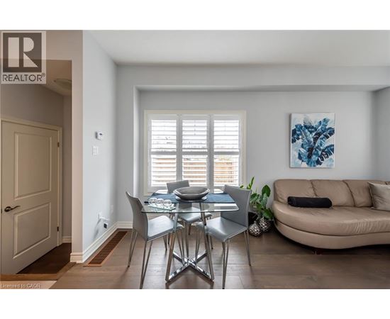 A dining room with a table and chairs.