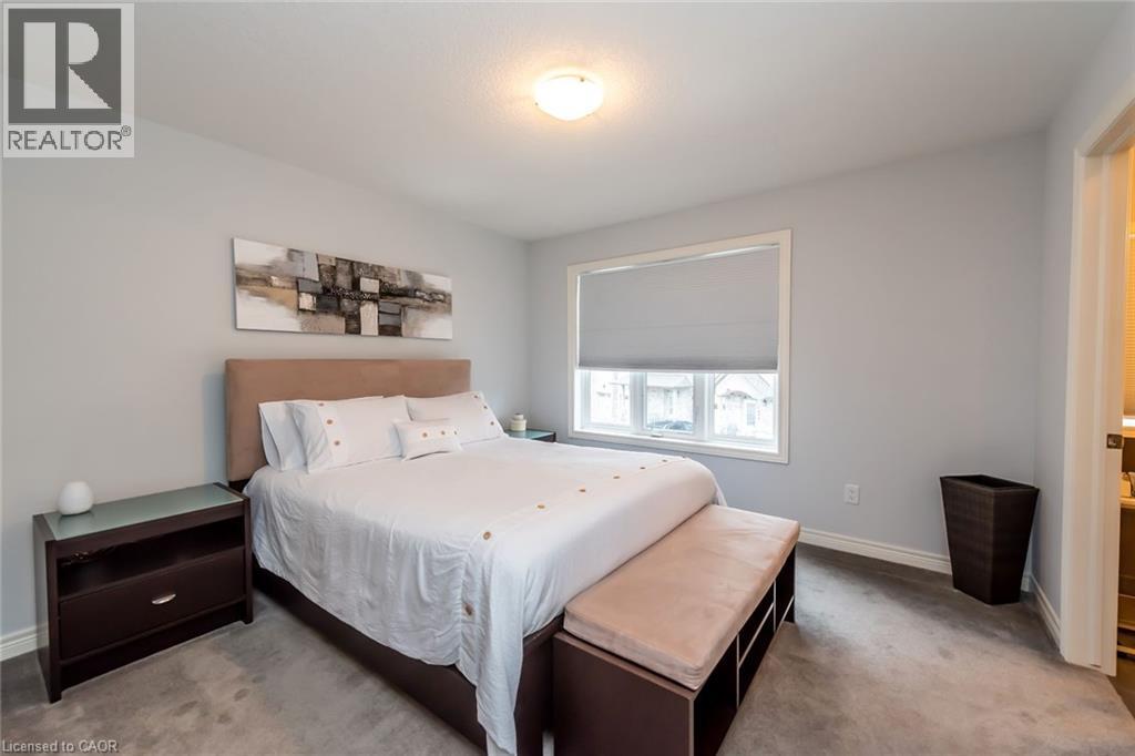 A bedroom with a large bed and a window.