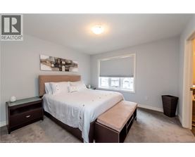 A bedroom with a large bed and a window.