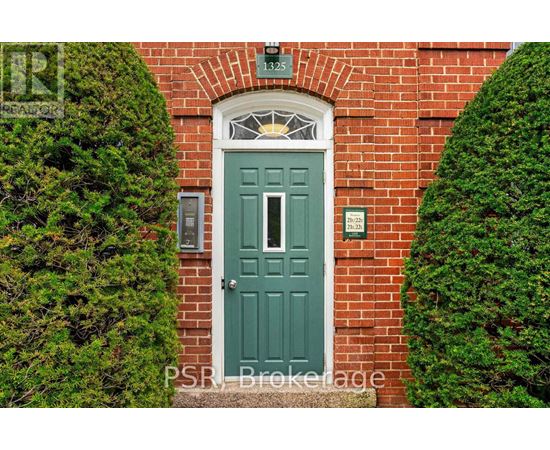 A green door is set in a brick wall.
