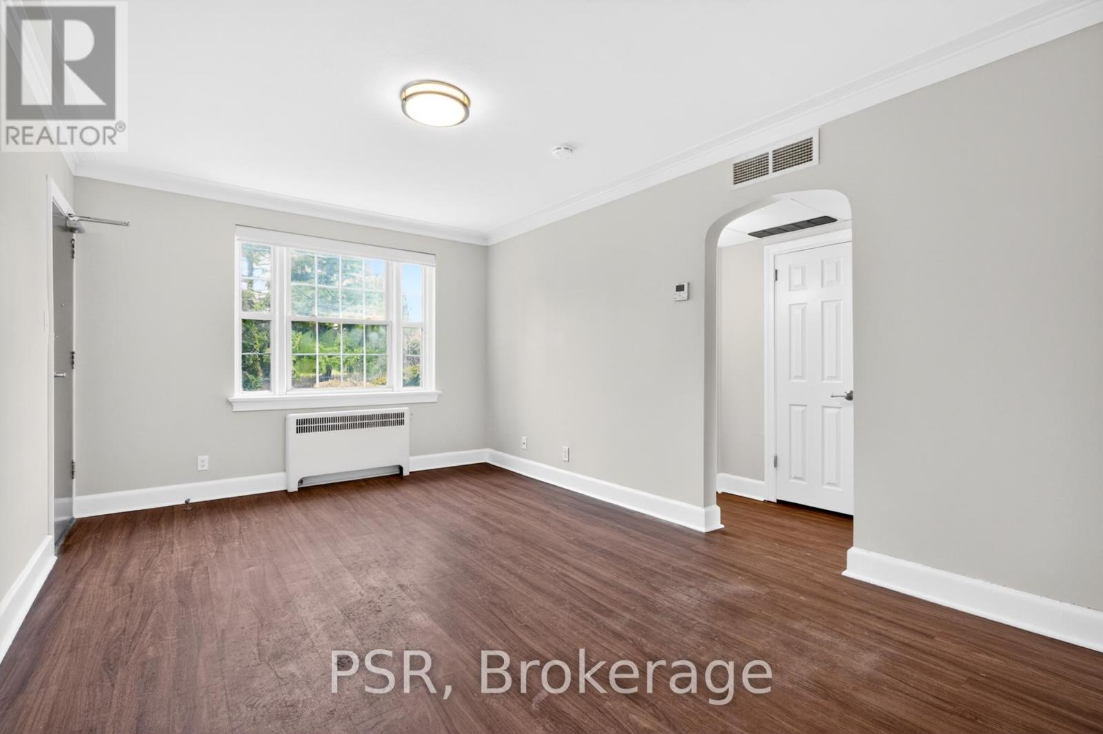 A room with a window and a door is for sale.