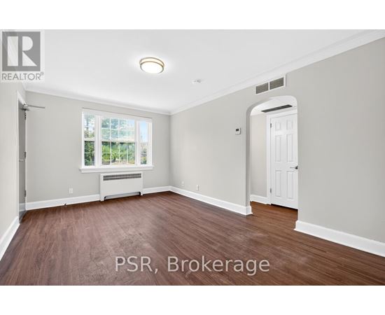 A room with a window and a door is for sale.