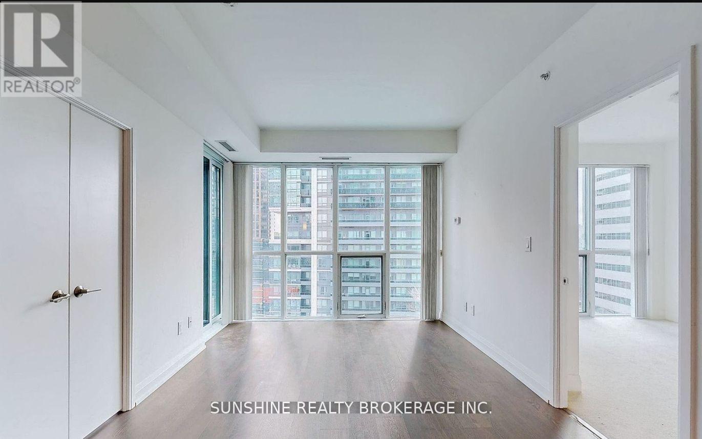 A spacious room with a view of a cityscape through the windows.