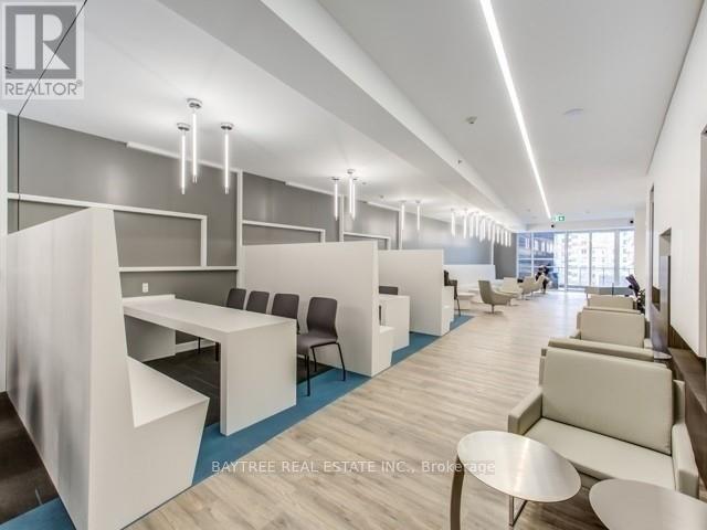 A modern office space with white furniture and a blue carpet.
