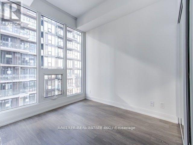 A room with a large window overlooking a building.