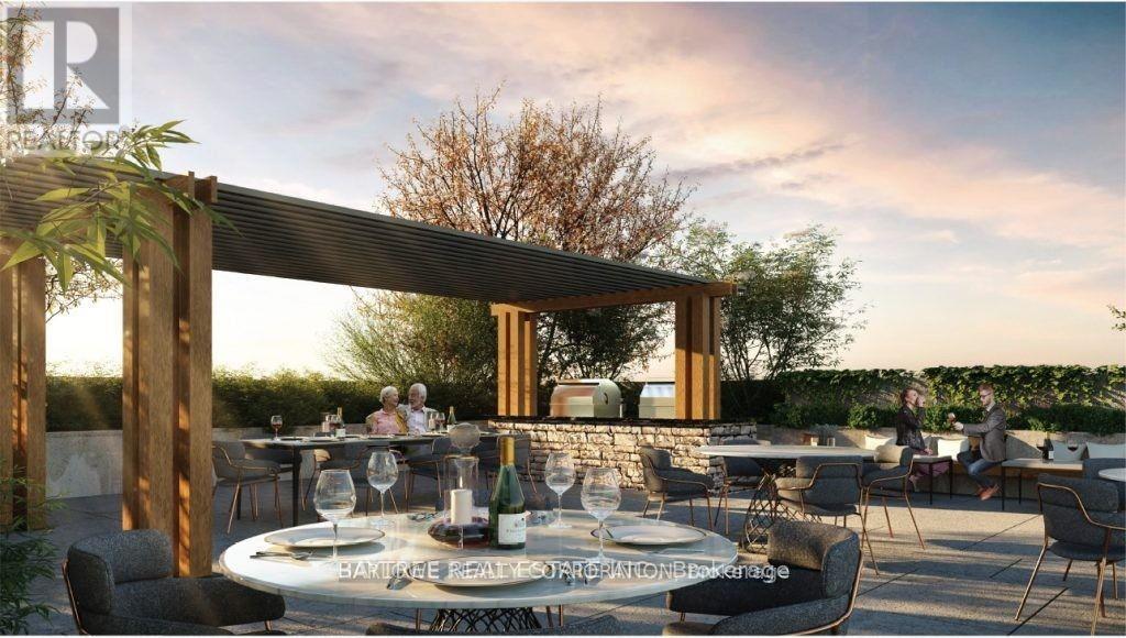 A dining area with tables set for a meal under a wooden pergola.