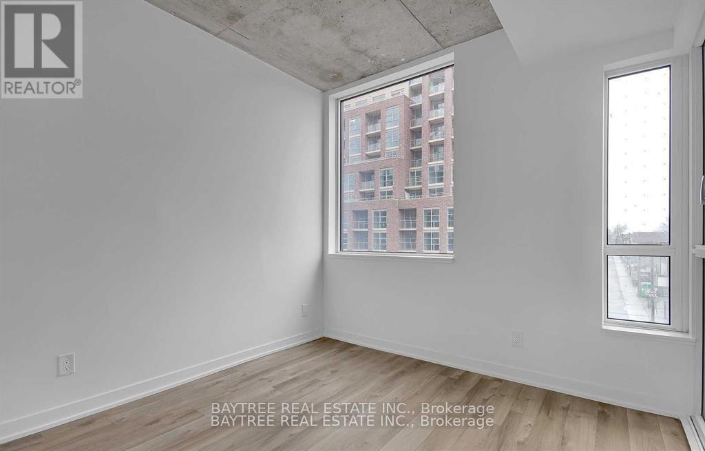 A room with a view of a building through a window.