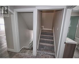 A stairway leads to a second floor bedroom.